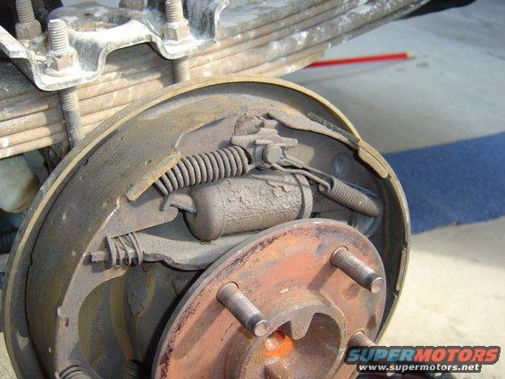 brakedrum.jpg Can you see what's wrong? The pad is gone... and also, the axle part isnt sposed to move in and out about 1/4" is it??  :-)