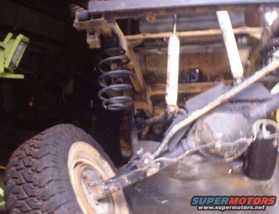 rear axle, coil spring, and shock absorber on a vehicle
