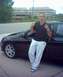 2004 Dodge SRT-4 - A man poses next to a black car, leaning against the driver's side door.