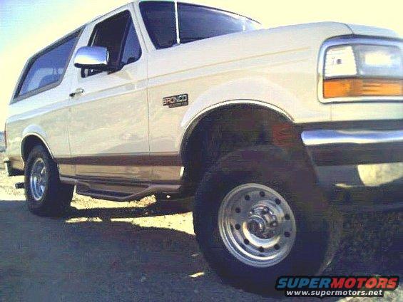 White 1995 Ford Bronco SUV, 3/4 front view, showing side panel and wheel