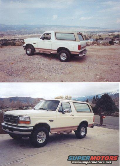 1995 Ford Bronco parked on a driveway with mountains in the background