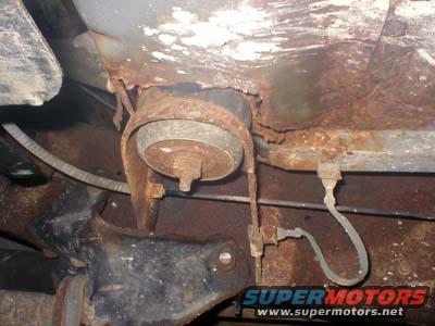 Underbody rust on vehicle frame with visible suspension components