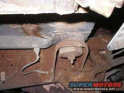 Close-up of rusted frame and suspension parts on a vehicle