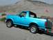 1994 Ford Bronco - This blue 1994 Ford Bronco navigates sandy terrain, its removable top exposing the interior to the open air.