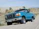1994 Ford Bronco - 1994 Ford Bronco navigating sand dunes under a clear sky.