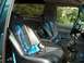 1994 Ford Bronco - The interior features racing seats and blue harnesses, with a custom center console.