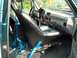 1994 Ford Bronco - The interior of a vehicle is shown, focusing on the driver's seat and dashboard area with blue seatbelts.