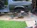 1990 Ford Bronco - 1990 Ford Bronco body undergoing work, rear axle removed and vehicle supported by jack stands.