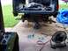 1990 Ford Bronco - The rear axle of a truck is undergoing maintenance, with the vehicle raised and components disassembled.