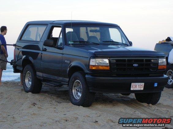 Black 1996 Ford Bronco on a sandy beach