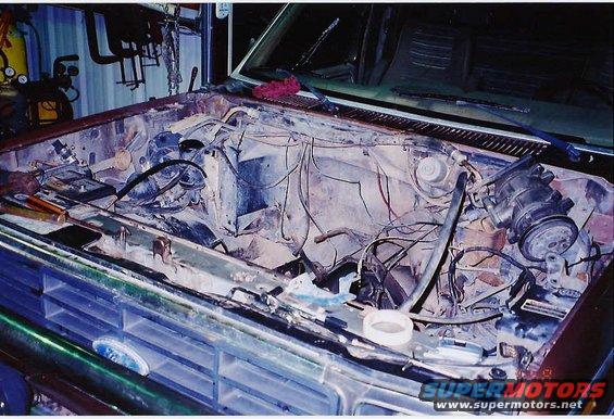 Ford Bronco engine bay with grille visible, showing engine removal in progress