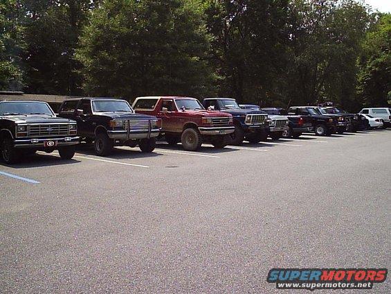 1989 Ford Bronco and other trucks parked in a lot