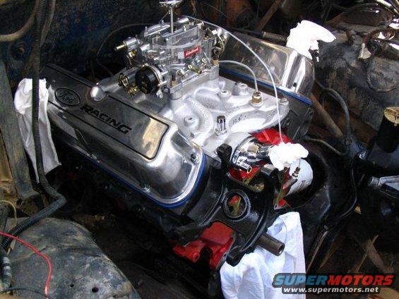Close-up of a Ford Racing engine with a carburetor and oil filter