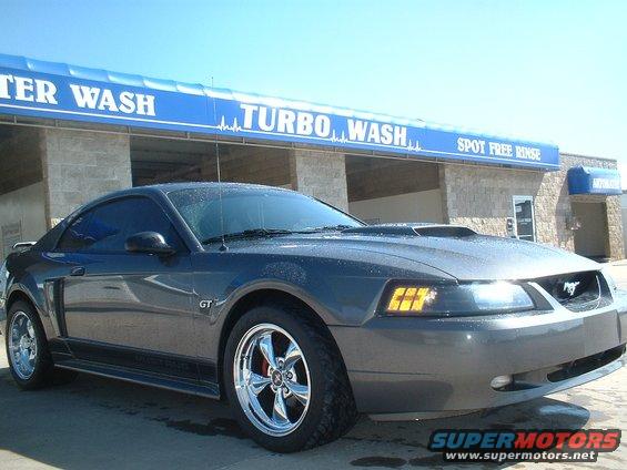 Dark grey 2003 Ford Mustang GT parked in front of a car wash