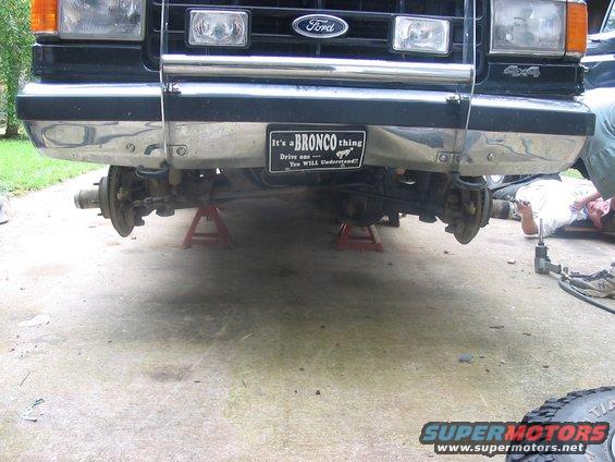 Ford Bronco front end on jack stands, chrome bumper, "It's a BRONCO thing" sticker