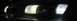 1995 Ford Taurus - Front view of a 1995 Ford Taurus showing its illuminated headlights in the dark.