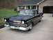 1957 Ford Ranchero - A classic black 1957 Ford Ranchero sits in a driveway, its iconic design.