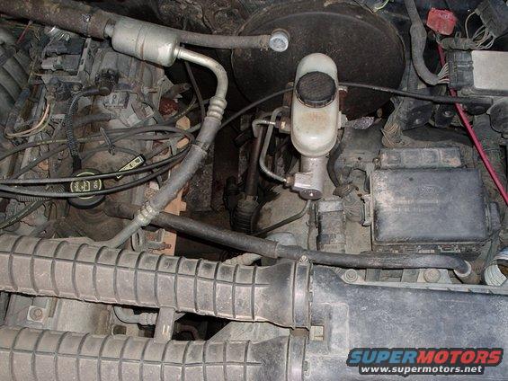 Engine bay with brake fluid reservoir and air intake components
