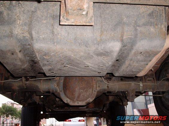 Underside view of a vehicle showing the fuel tank and rear differential