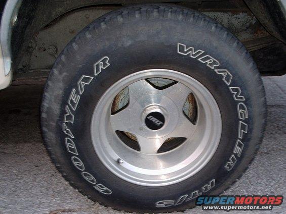 Close-up of a Goodyear Wrangler tire on a five-spoke wheel with a 'BBS' center cap