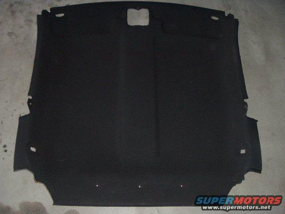 Black car headliner with cutouts for lights and sunroof