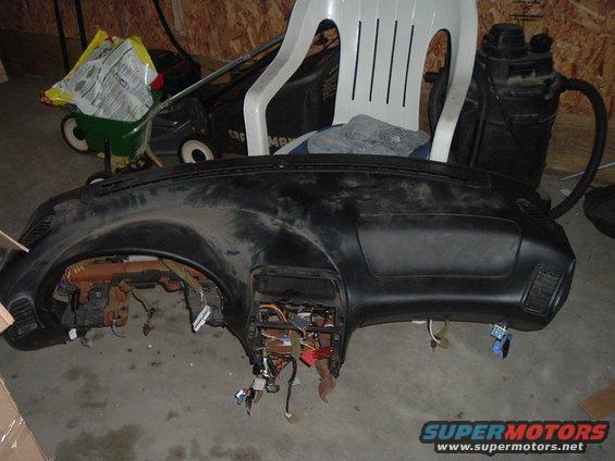 Removed car dashboard with exposed wiring and components