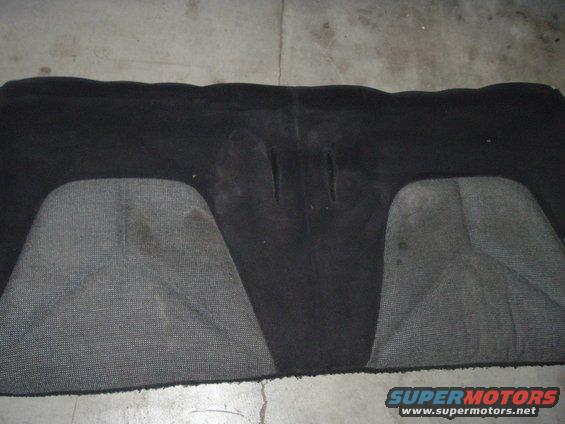 Black car floor mat with two gray fabric inserts and two cutouts for seat bolts