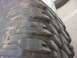 1990 Ford Bronco - A detailed view of a tire's tread pattern, showing significant wear and deep channels.