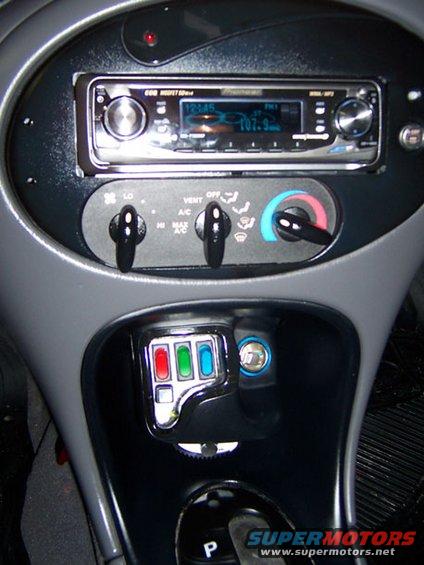 1999 Ford Taurus dashboard with aftermarket stereo, climate controls, and auxiliary buttons