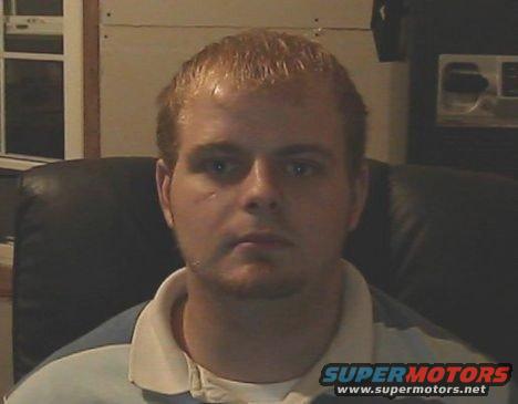 Man in chair with Supermotors.net watermark