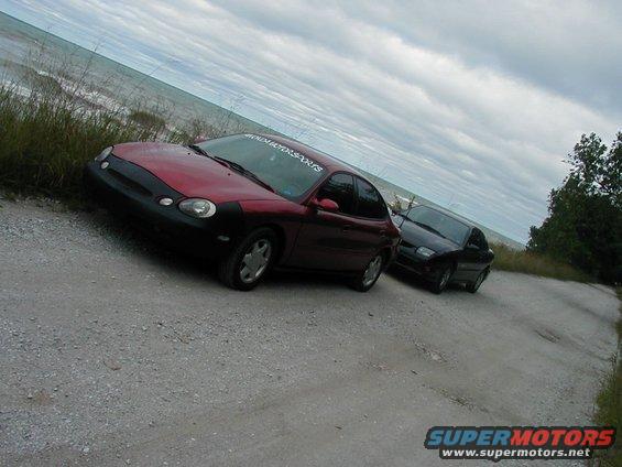 1997 Ford Taurus, red, 3q-front view, parked by water