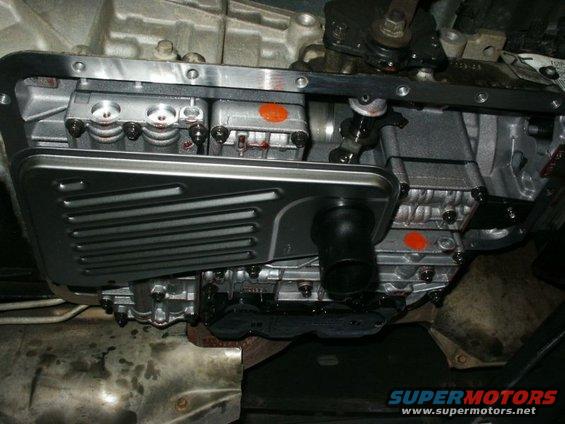 Transmission pan and filter removed, showing internal components and fluid