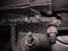 1968 Ford Mustang - This close-up shows a damaged steering bracket, with evidence of metal fatigue and wear around the mounting bolts.