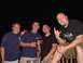 1979 Ford Bronco - Four men gather for a nighttime photo, with one enthusiastically making a rock-on hand gesture.