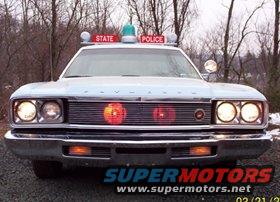 Front view of a light blue police car with a light bar and "STATE POLICE" text