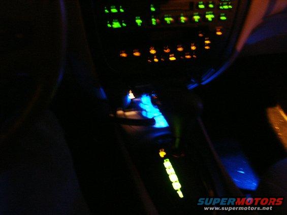 car interior at night, glowing dashboard and shifter