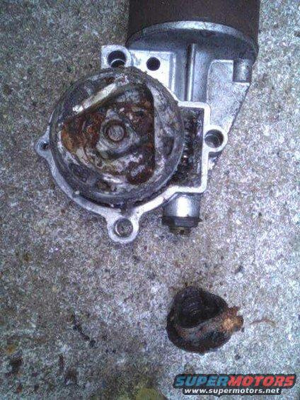 Rusted starter motor part on concrete