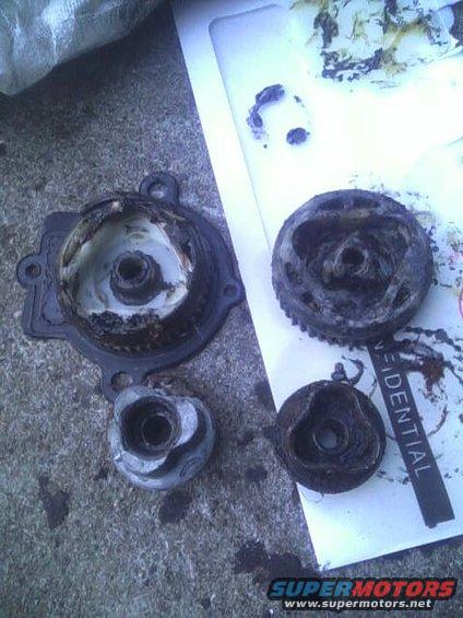 Broken engine parts on a white paper with the word 'RESIDENTIAL' visible