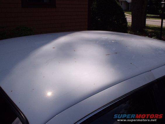 White car roof with sunlight casting shadows