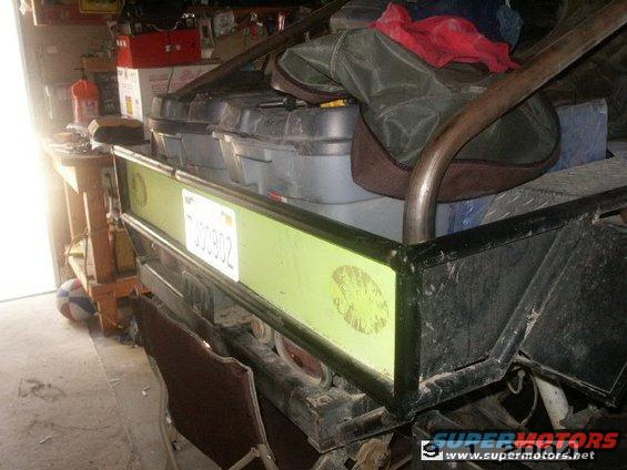 Rear of utility vehicle with storage containers and license plate 000902