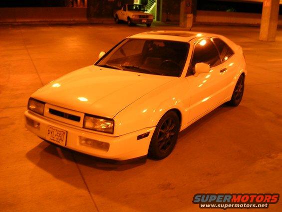 White 1990 Volkswagen Corrado coupe parked at night, front quarter view