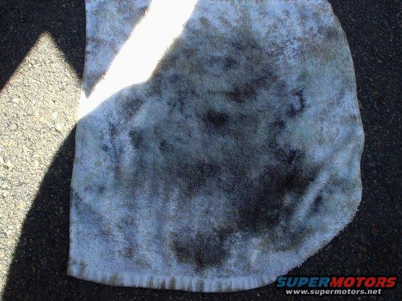 Towel with oil stains on asphalt