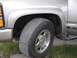 2000 Chevrolet Tahoe - This photo shows the front wheel and fender of a Chevrolet truck, likely a Tahoe, with a visible 'Tahoe' badge.