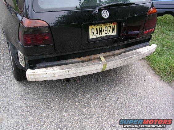 Black Volkswagen Golf rear bumper removed, showing frame and tow strap