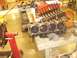 1973 Mercury Cougar - Disassembled engine components are laid out on a workbench in a garage setting.