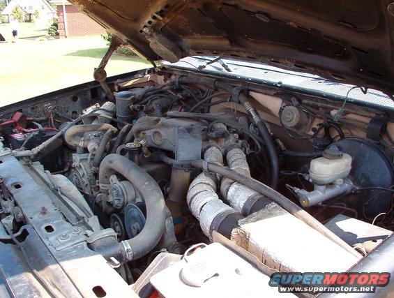 engine-bay.jpg The '95 4.9L in the '85 F250 front clip on the '82 body tub on my '83 frame.  If you look VERY closely & know your Ford truck parts, you'll spot the '80-85 core support, '83 condenser-to-evaporator line, '87-97 starter relay, Radio Shack loudspeaker, '80-86 reel light, '80-86 wiper motor, '87-93 brake booster/MC, '92-97 power distribution box, '87-95 air filter box & hoses (covered with foil-faced foam tape), and '92-96 coolant/wiper tank.

The reason for the air filter wrapping is explained in the RESULTS pages of [url=http://www.performanceunlimited.com/projectmpg/]Project MPG[/url].