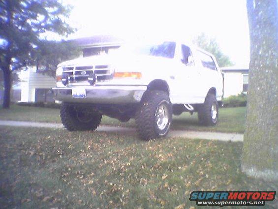 1993 Ford Bronco parked on a lawn with a house in the background