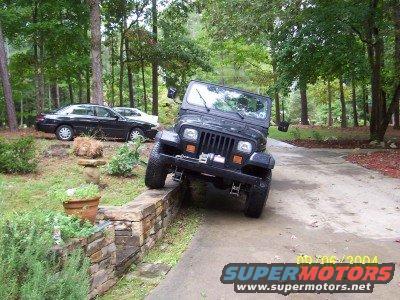 Black 1994 Jeep YJ on stone wall