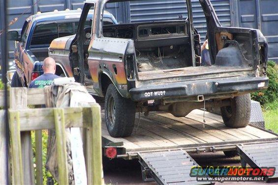 Black Ford Bronco on a trailer, rear view, with "GOT MUD?" text