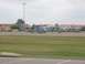 1988 Ford Bronco - Multiple helicopters are lined up on the tarmac at an airbase under a cloudy sky.